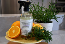 Load image into Gallery viewer, Image of the Lavender Harmony Natural Multi-Surface Cleaner bottle with oranges and western red cedarwood in the background.
