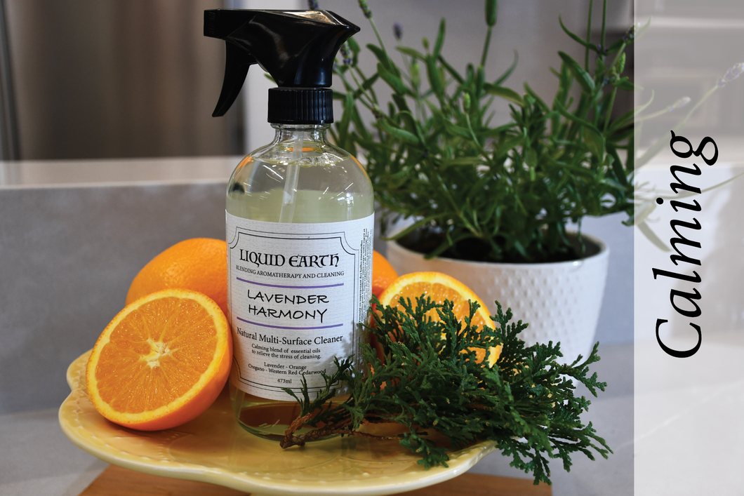 Image of the Lavender Harmony Natural Multi-Surface Cleaner bottle with oranges and western red cedarwood in the background. The word Calming is highlighted to depict the emotion delivered by the cleaner.